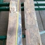 8.3 Cockpit area - the two old boards between the keel boxes and the engine space - showing the rot and bits of the glass fibre matting which had been leyered up on top of mud!