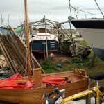 A169 emerges from the canvas tent 2017. The shopper dinghy in the foreground is her tender.