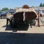 The lifting beams and jacks are called into play again to lower the boat fully onto the trailer.