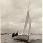 Sujanwiz helmed by Alan Vines sailing on the Hamble with his brother in law Jimmy Mumford crewing. Fairey Marine factory in the background.
