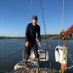 Pleased skipper standing by pushpin