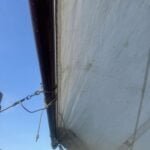 The replacement boom, from A154 Deannie, has chromed bronze fittings. The mainsail is now loose footed.